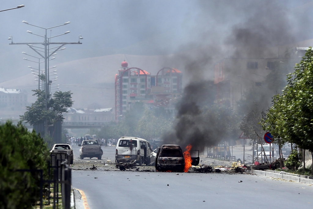 Fire and smoke rise at the site of a suicide attack during clashes with Taliban fighters in front of the Parliament in Kabul Afghanistan on Monday