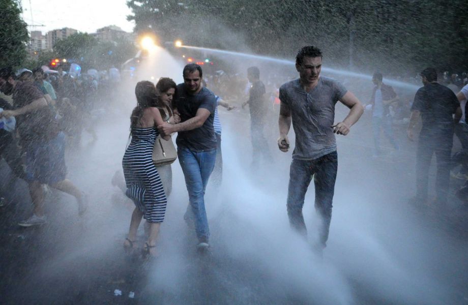 Armenian police use water cannons to disperse protesters demonstrating against an increase in electricity prices in the Armenian capital of Yerevan Tuesday