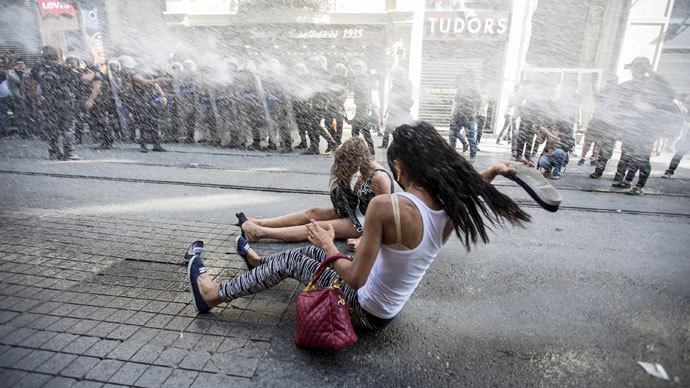 Riot police use a water cannon to disperse LGBT rights activist before a Gay Pride Parade in central Istanbul Turkey