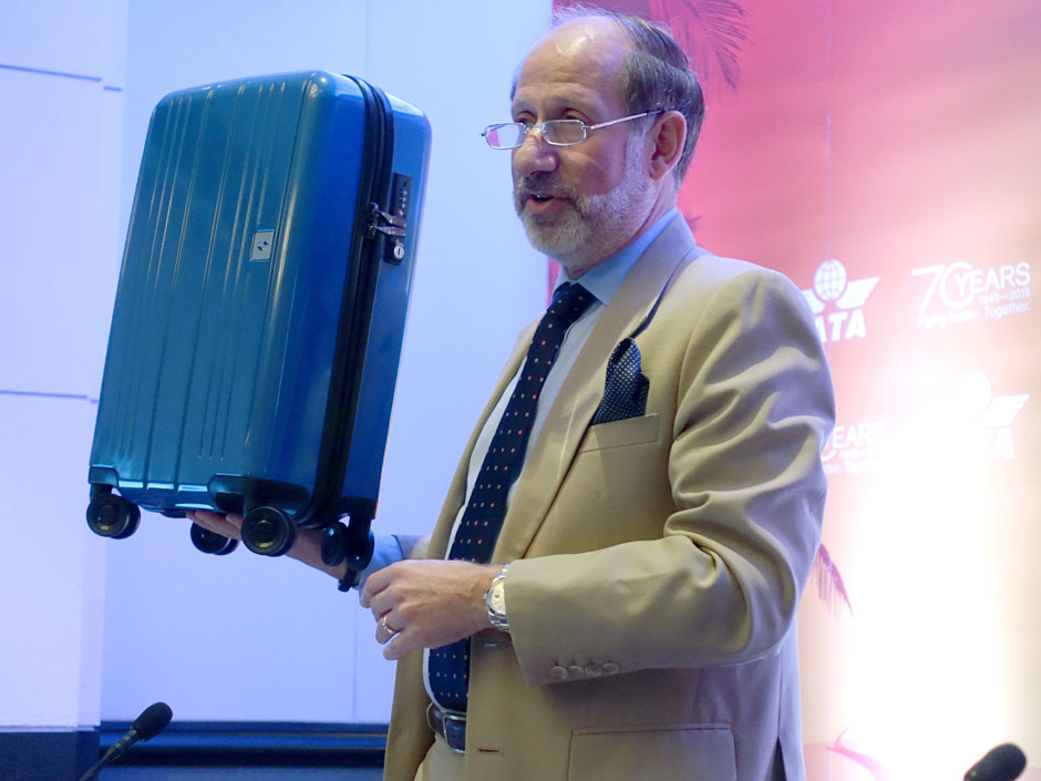 International Air Transport Associations senior vice president for airport passenger cargo and security Tom Windmuller holds up the group's proposed ideal-sized carry-on bag