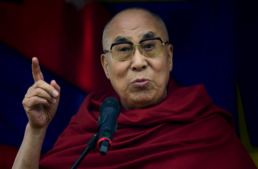 The Dalai Lama greets well wishers as he addresses a crowd gathered at the Stone Circles at Worthy Farm in Somerset during the Glastonbury Festival in Britain