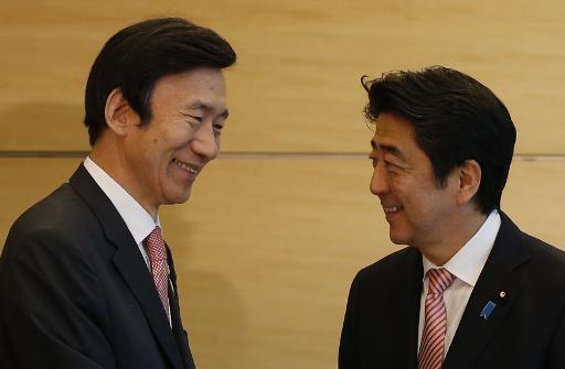 Japan s Abe pledges to improve ties with South Korea