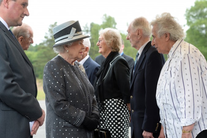 Queen Elizabeth II third left and Prince Philip Duke of Edinburgh second left talk with contemporary witnesses Doreen Levy third right Capt. Eric Brown second right and Anita Lasker-Wallfisch right during their visit at the former Nazi concentra