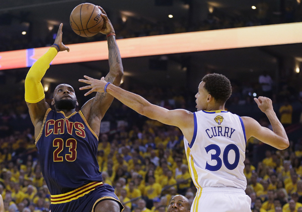 The Cavaliers’ Le Bron James drives against Golden State’s Andrew Bogut during Game 4 of the NBA Finals