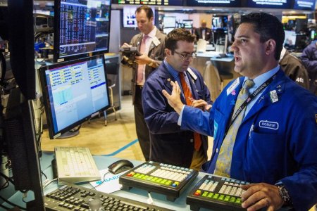 Traders work on the floor of the New York Stock Exchange shortly after the opening bell