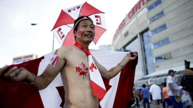 A Canadian fan waits outside before the opening ceremony for the Pan Am Games in Toronto on Friday