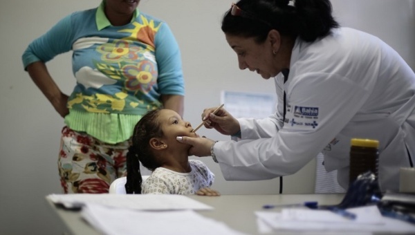 A Cuban doctor examines a young patient. Cuba is widely viewed as having one of the best health systems in the region