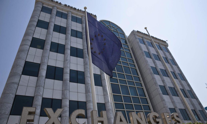 A European Union flag flutters outside the Athens stock exchange Greece