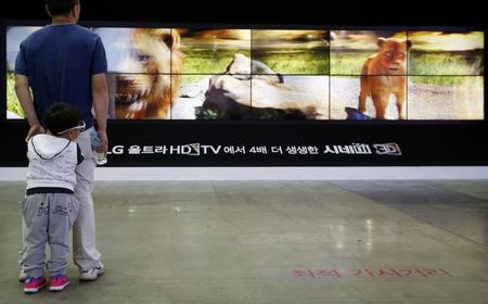 A man and his son look at LG Electronics&#x27 3D TV sets during the 2014 Korea Electronics Show in Goyang