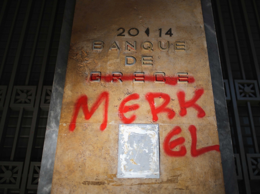 A sign outside the Bank of Greece is defaced with graffiti to read ‘Banque de Merkel