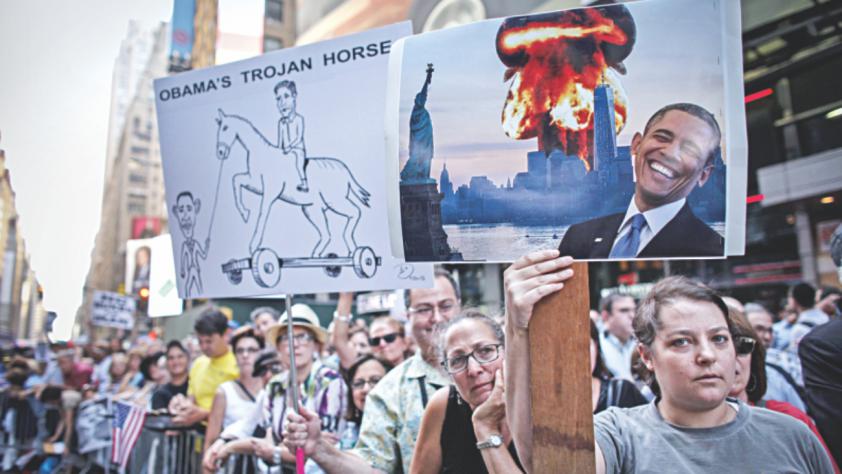 A woman holds a poster on Wednesday as she takes part in a rally on Times Square in New York opposing the nuclear deal with Iran