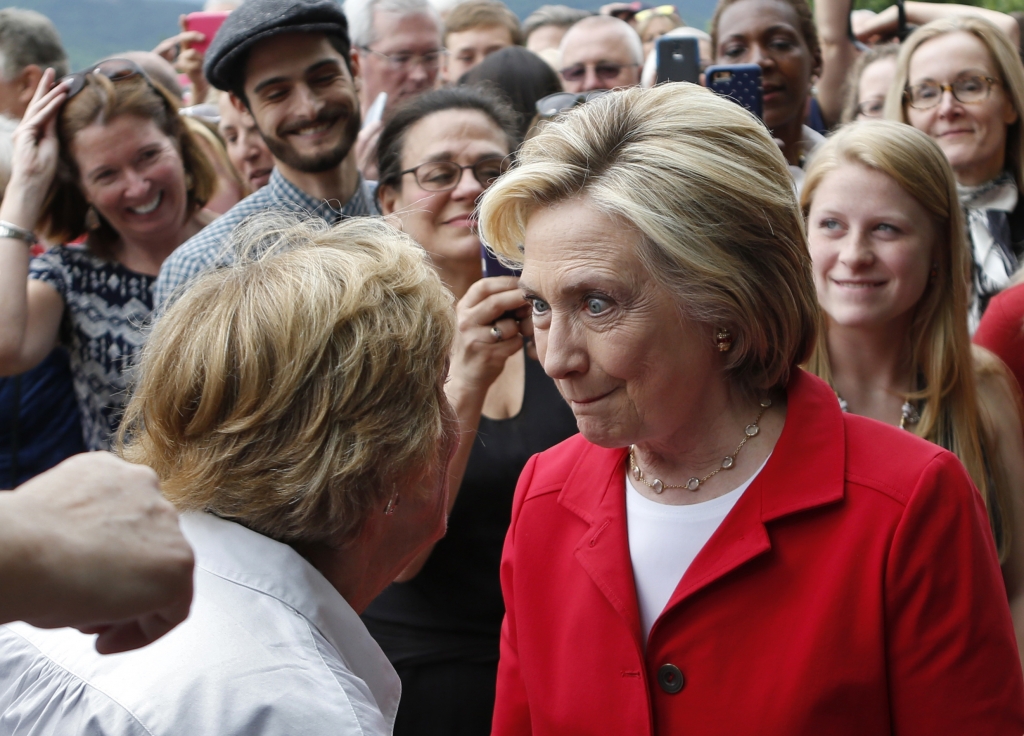 Democratic presidential candidate Hillary Rodham Clinton makes a face with a supporter at an organizing event Saturday