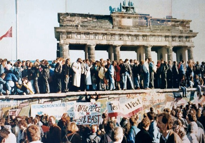 People on top of the Berlin Wall days before it was torn down