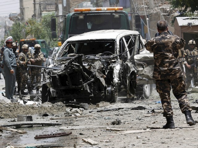 Afghan security forces stand at the site of a suicide attack in Kabul Afghanistan