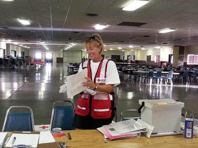 An American Red Cross worker prepares for potential evacuees from the Blue Creek fire