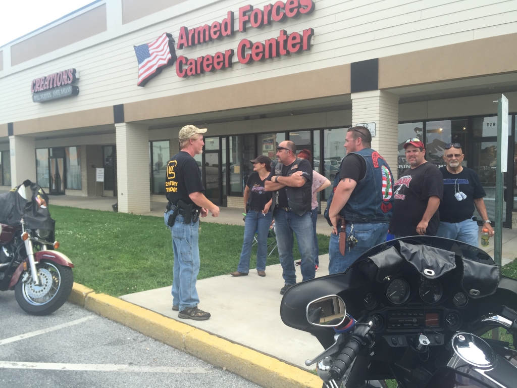 Armed civilians station themselves outside an Armed Forces Career center in Manchester Township York County