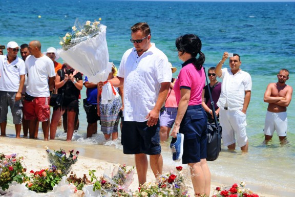 Mourners lay flowers at the site of the recent attack against tourists in Tunisia