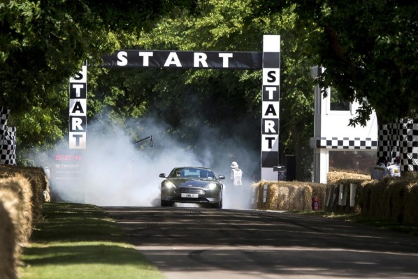 Aston Martin's DB9 GT smokes the tyres at the start of a run at the Goodwood Festival of Speed