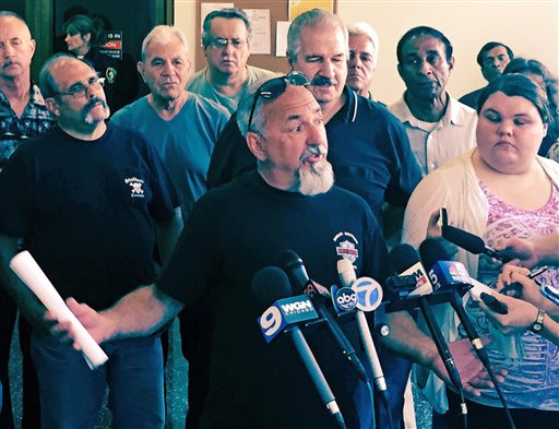 Charles Lomanto a 28 year employee of Chicago's Streets and Sanitation Department speaks at a news conference Friday