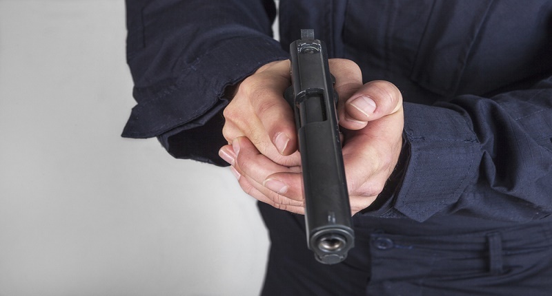 Police officer holding gun