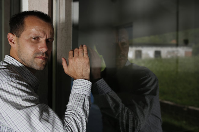 27 2015 Srebrenica massacre survivor Nedzad Avdic, 37 looks through a window inside the elementary school where he was brought by Serb soldiers in the village of Petkovci near Zvornik 200 kilometers nor