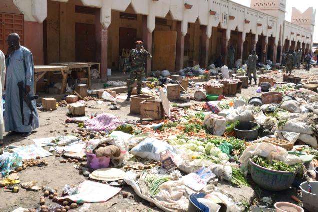 Soldiers stand guard at a market on Saturday in N'Djamena after a suicide bomb attack