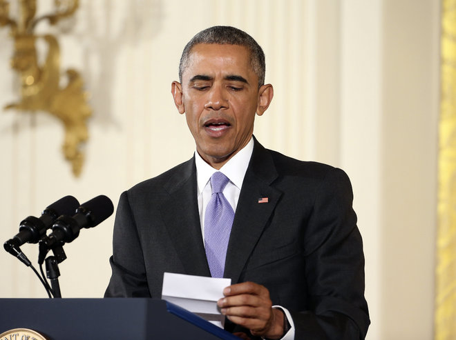 President Barack Obama looks over his notes as he answers questions about the Iran nuclear deal during a news conference in the East Room of the White House in Washington Wednesday