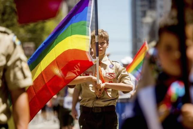 Boy Scout Casey Chambers carries a rainbow flag during the San Francisco Gay Pride Festival