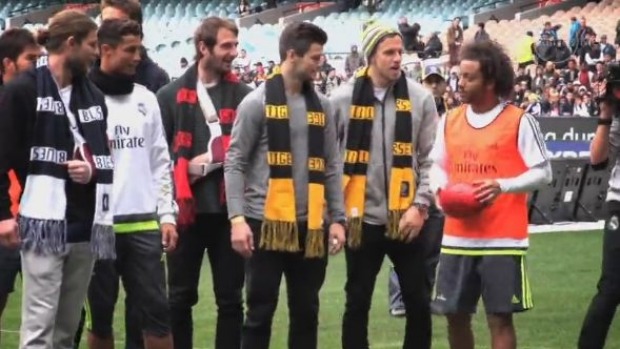 Brazilian full-back Marcelo works on his kicking with a couple of AFL stars