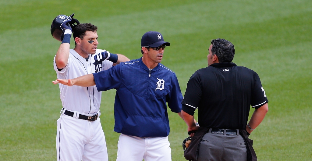 DETROIT MI- JULY 19 Detroit Tigers manager Brad Ausmus #7 gets in between home plate umpire Manny Gonzalez and Ian Kinsler during the third inning of the game against the Baltimore Orioles