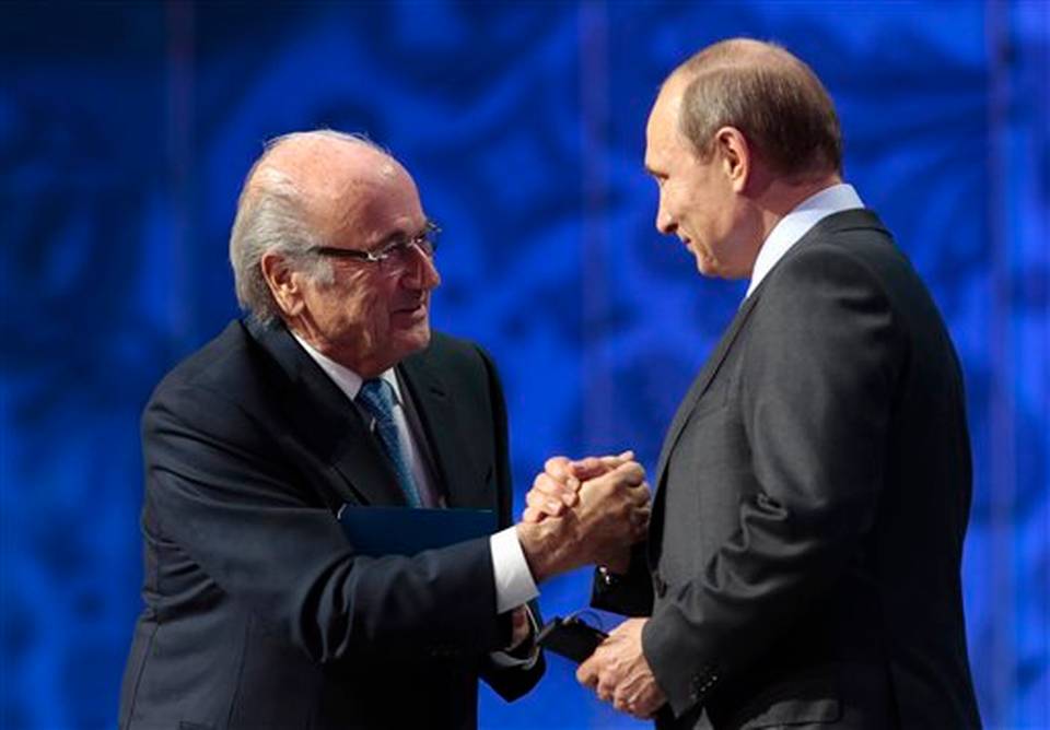 FIFA President Sepp Blatter left shakes hand with Russian President Vladimir Putin during the preliminary draw for the 2018 soccer World Cup in Konstantin Palace in St. Petersburg Russia Saturday