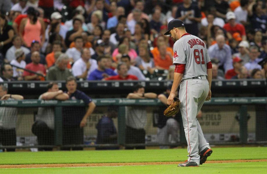 Boston Red Sox pitcher Brian Johnson walks off the field after giving up two runs to the Houston Astros and being removed during the fifth inning of a baseball game Tuesday