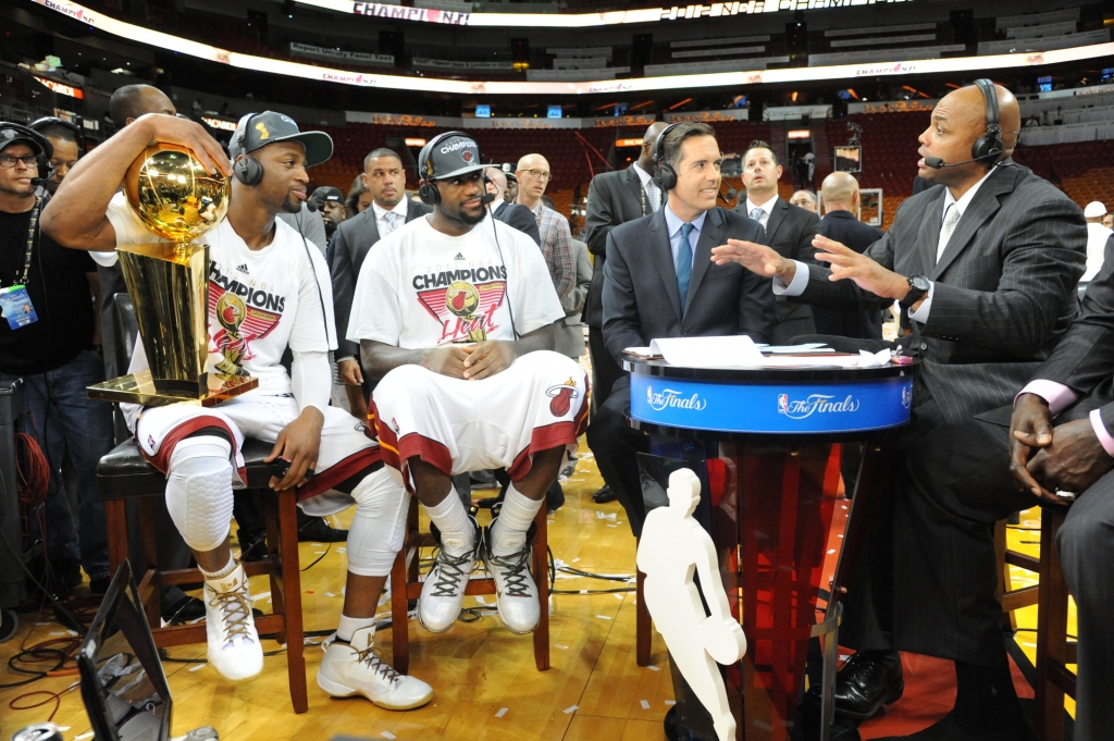 MIAMI FL- JUNE 21 Dwyane Wade #3 and Le Bron James #6 of the Miami Heat holds the Larry O'Brien Trophy as they speak to NBATV analyst Matt Winer and Charles Barkley after winning the Championship against the Oklahoma City Thunder during Game Five