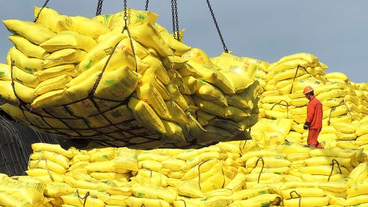 A worker stands on piles of industrial products before exporting at a port of Lianyungang China