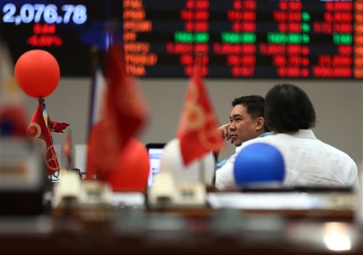 Filipino traders chat during a lull in trading at the Philippine Stock Exchange at the financial district of Makati south of Manila Philippines Monday