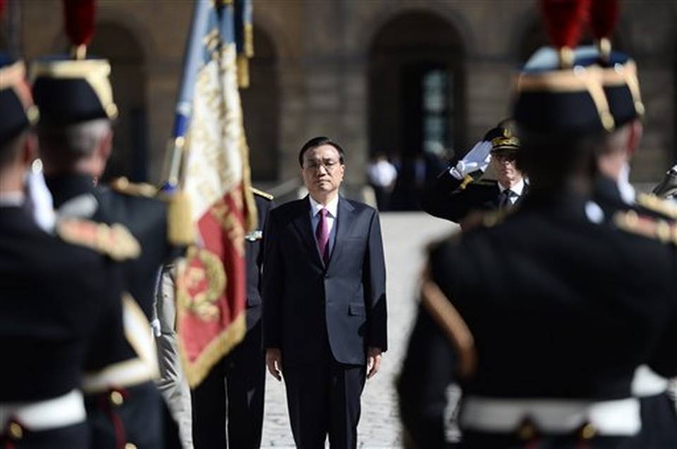 Chinese Prime Minister Li Keqiang center attends a welcoming ceremony at the Hotel National des Invalides in Paris France with his French Counterpart Manuel Valls upon his arrival for a three-day visit during which a raft of accords are expected to