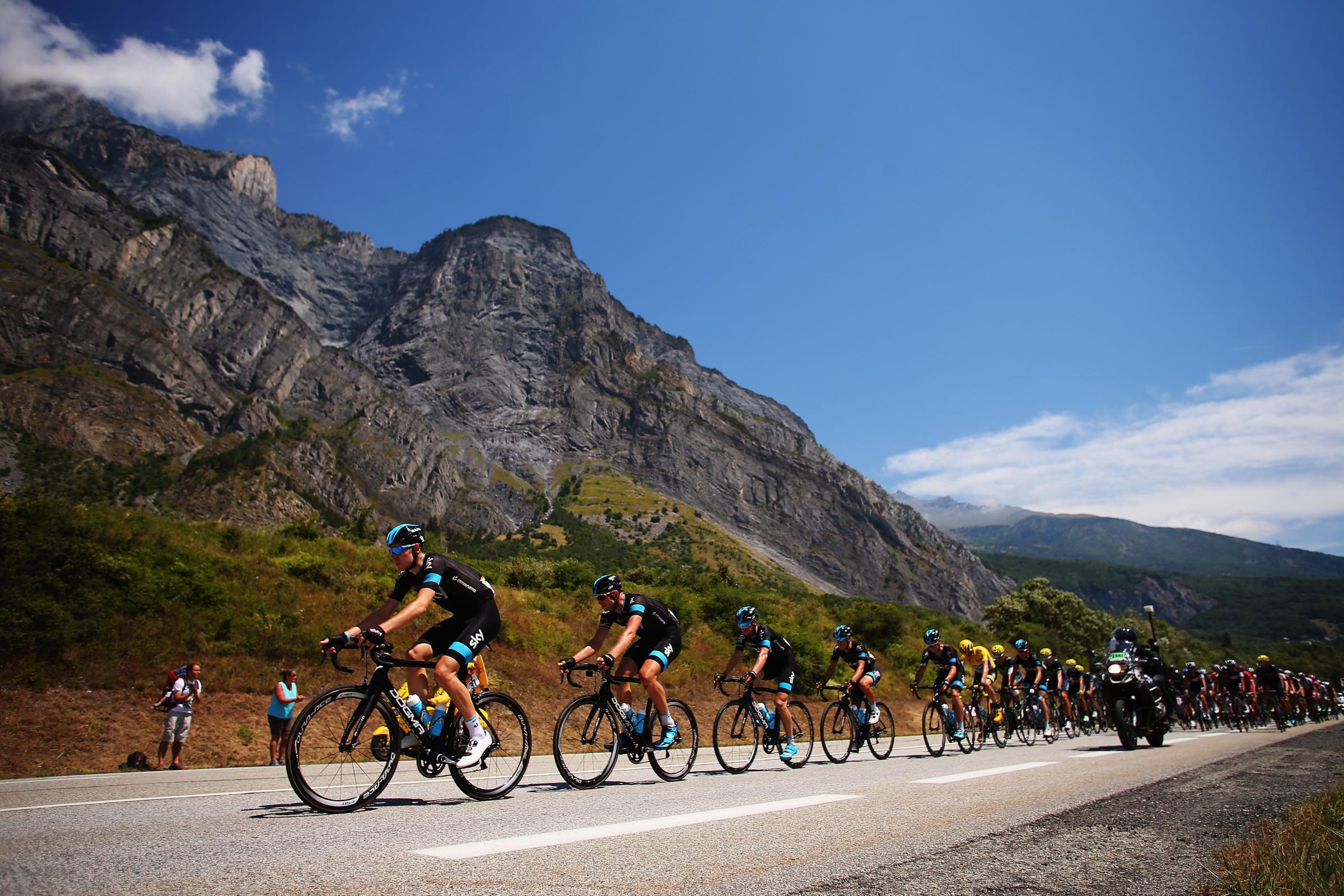 Race leader Chris Froome rides with team-mates amongst the peloton during the 20th stage between Modane Valfrejus and L'Alpe d'Huez