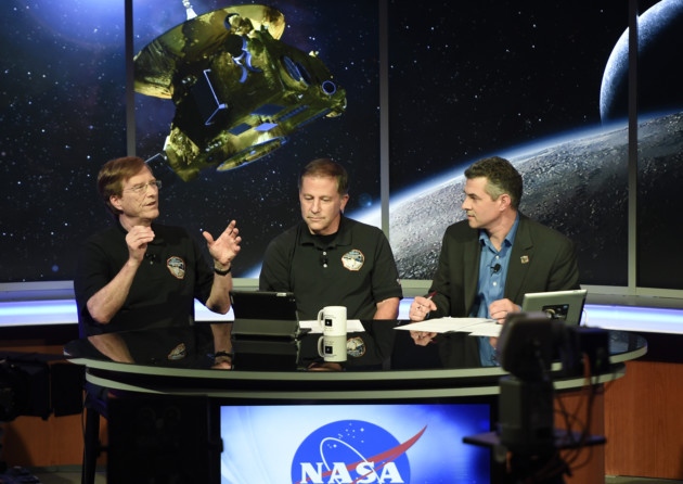 New Horizons scientist Hal Weaver left talks with Mark Holdridge centre and Mike Buckley as they await information from from the New Horizons spacecraft as it passed Pluto earlier this week