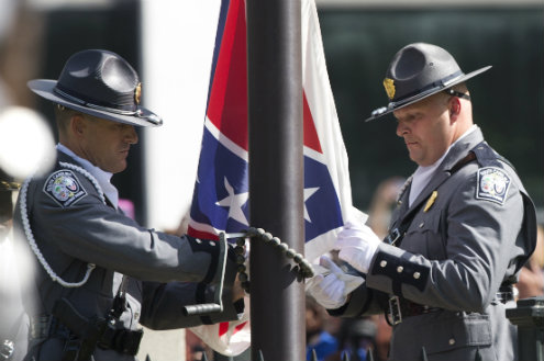 An honor guard from the South Carolina Highway patrol lowers the Confederate battle flag as it is removed from the Capitol grounds July 10 in Columbia S.C