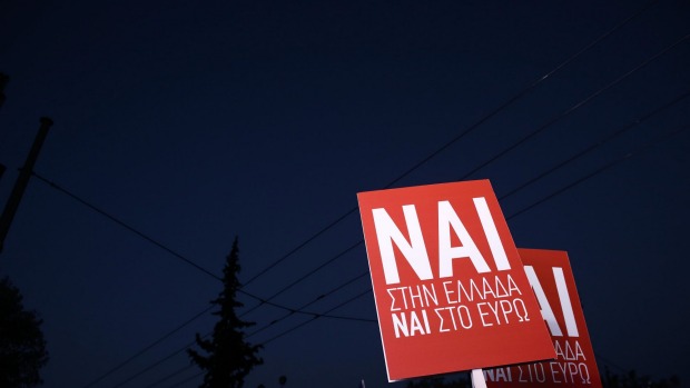 Supporters raise banners for the'NAI or'Yes vote during a campaign rally in support of the European Union ahead of Sunday's referendum in Athens Greece