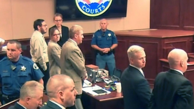 Colorado movie theatre shooter James Holmes second from left stands along with defense and prosecution teams