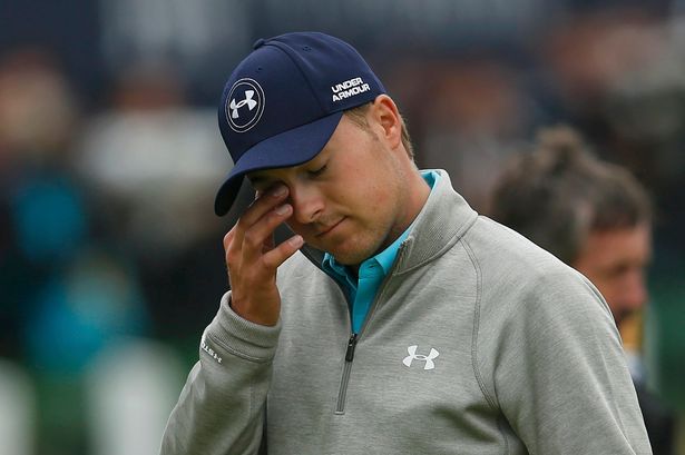 Dejected Jordan Spieth wipes his eye on the 18th green after completing his final round