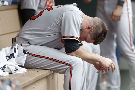 Bud Norris hangs his head in the dugout after the sixth inning where he gave up three runs on two home runs by Minnesota Twins Brian Dozier and Joe Mauer in a baseball game Wednesday