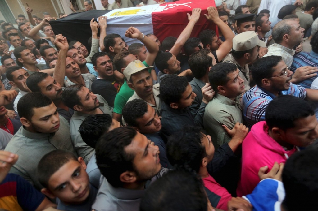 Relatives of 21-year-old Mohamed Adel one of the army officers who died in yesterday's Sinai attacks carry his coffin during the funeral in Al-Kaliobeya near Cairo Egypt. – Reuters pic