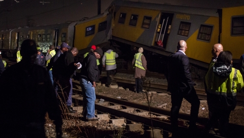 Emergency workers search the scene at yesterday's Johannesburg train crash