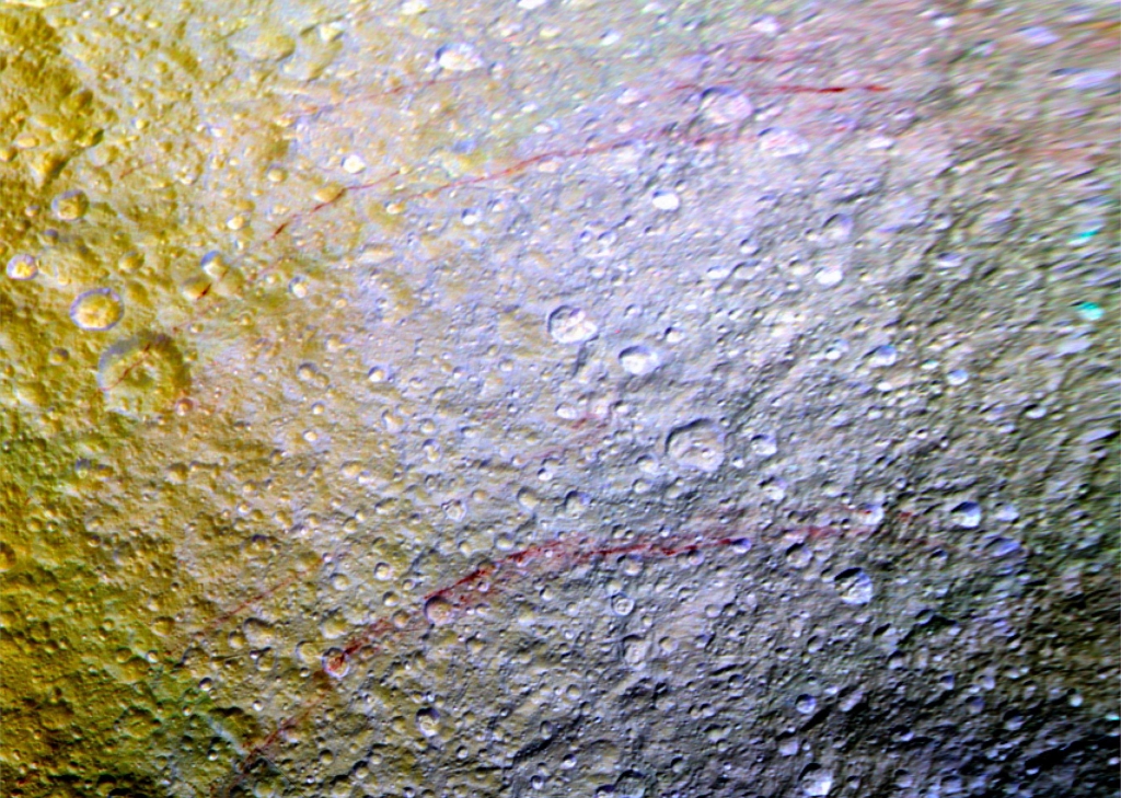 Enhanced-color image from Cassini showing red streaks on Tethys