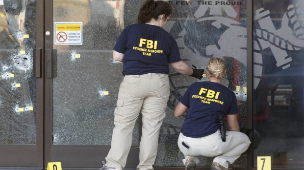 FBI agents gather evidence at the Armed Forces Career Centre in Chattanooga Tennessee