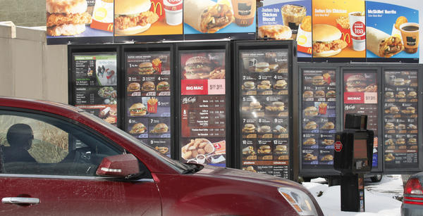 A patron looks at the menu at McDonald's in Williamsville N.Y. Monday Jan. 26 2009. David Duprey Associated Press Enlarge