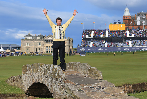 ST ANDREWS SCOTLAND- JULY 17 Sir Nick Faldo of England waves to the crowd as he stands on Swilcan Bridge during the second round of the 144th Open Championship at The Old Course