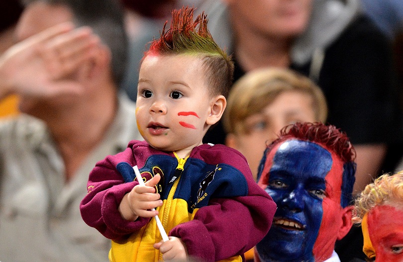 Father and son enjoy the NRL match between the Brisbane Broncos and the Newcastle Knights in Brisbane. Bradley Kanaris  Getty Images